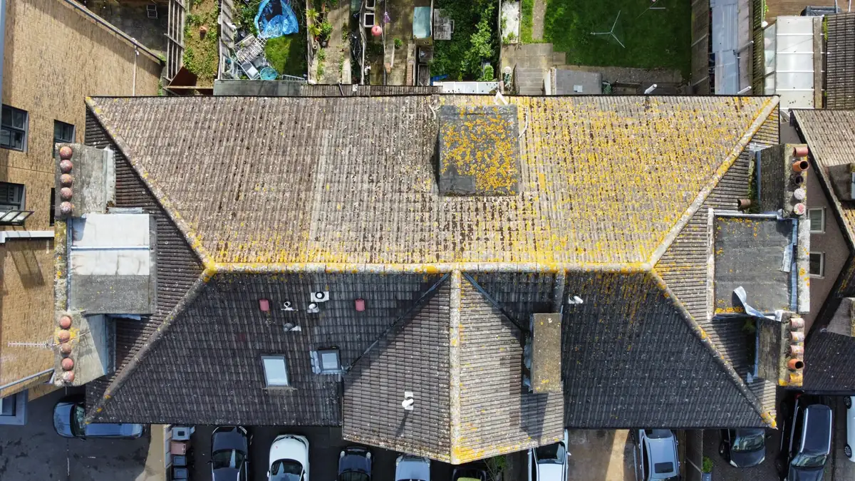 Aerial drone survey of a tiled roof in London showing lichen growth and moss in the valleys