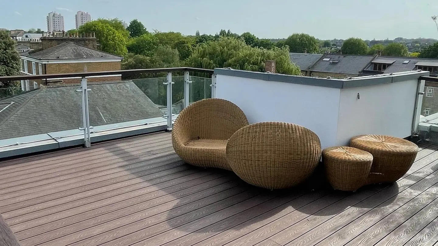 Rooftop terrace with composite decking and glass balustrade on a London property