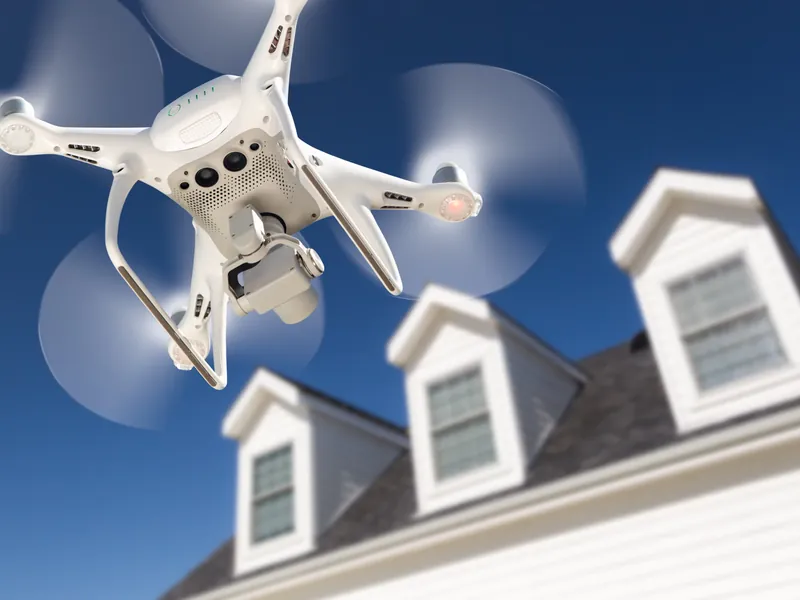 Drone carrying out a routine roof inspection